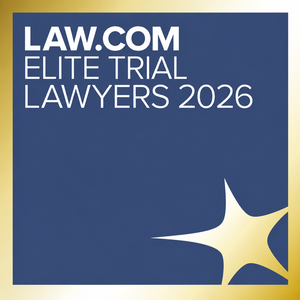Awards badge for Law.com Elite Trial Lawyers 2026 Law.com Elite Trial Lawyers 2026 logo featuring white lettering on a dark blue background, framed by a gold border with a gold starburst in the lower-right corner